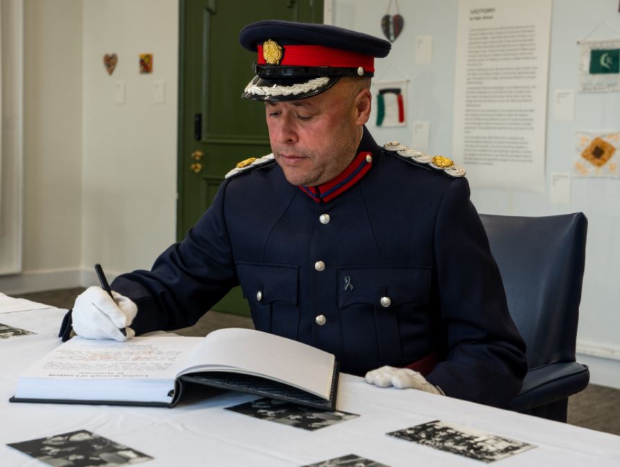 Christopher signing Lambeth's book of condolence